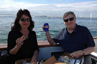 Couple enjoying beverages on the Schooner Adirondack II in Boston Harbor for a day Sail