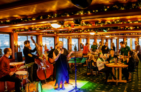 Band playing on inside of Northern Lights for a Holiday Cruise in Boston Harbor