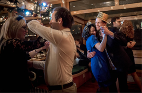 People dancing in the main salon of yacht Northern lights for a Holiday Cruise in Boston Harbor