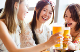 three woman celebrating, and clanging their drinks together