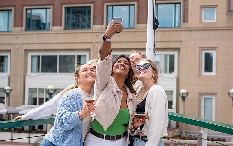 a group of women taking a selfie while on a motor yacht