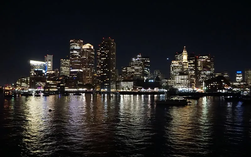 nighttime view of downtown Boston lit with city lights
