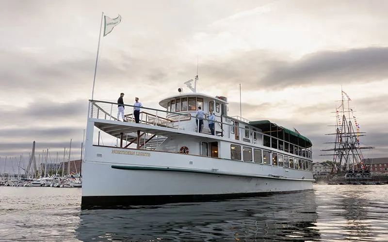 the motor yacht Northern Lights sitting on the water, outside of the Boston harbor