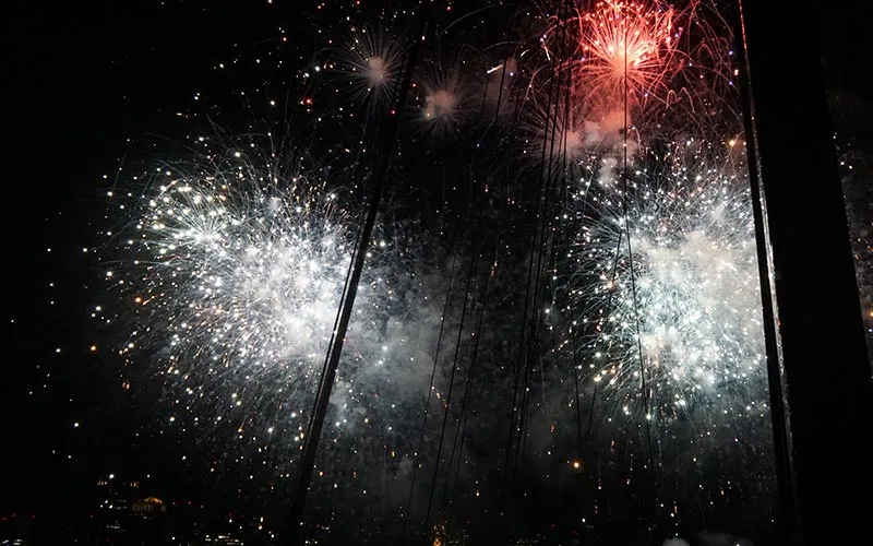 fireworks being shot off into the night sky above the Boston harbor