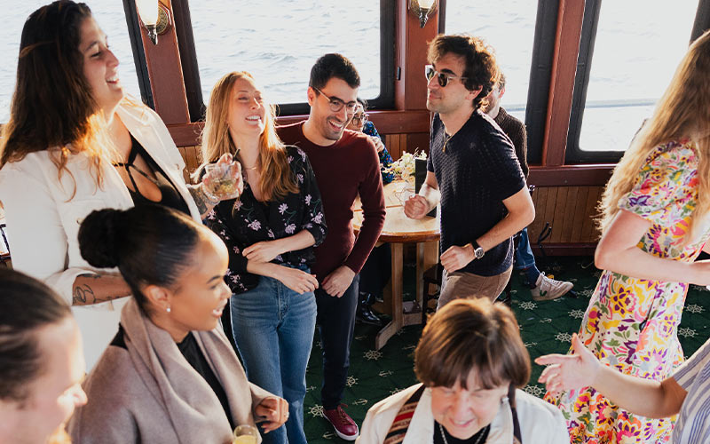 Boston_Live-Irish-Music-Slider-4 a group of people dancing inside of a Boston motor yacht from classic harbor line