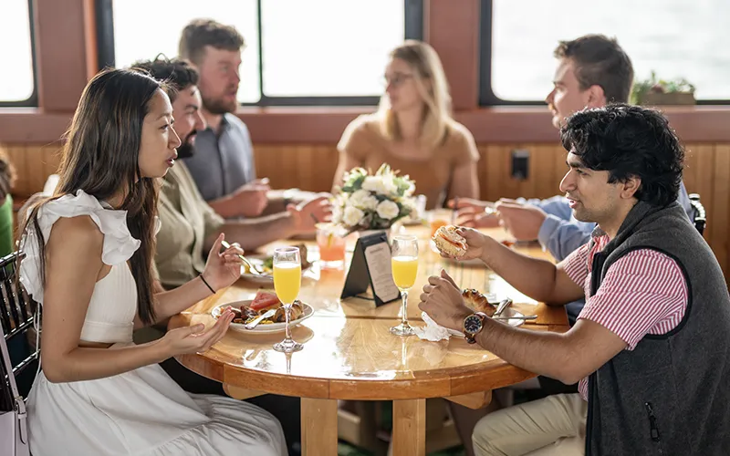 Guests enjoying a brunch on the yacht Northern Lights in Boston Harbor with Classic Harbor Line Boston