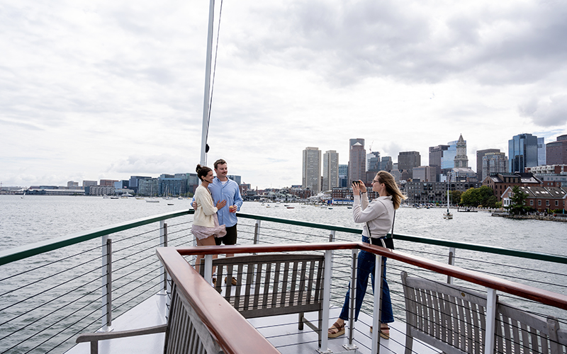 A couple getting their photo taken on the bow of Yacht Northern lights for a sightseeing cruise
