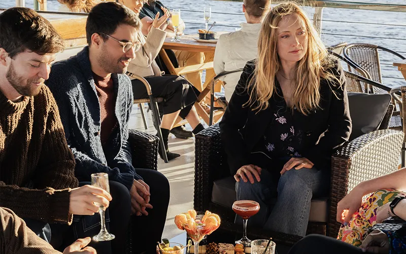 Guests on the upper deck of yacht Northern Lights for a sunset cruise in Boston Harbor