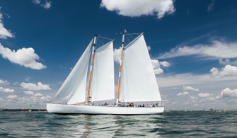the Schooner Adirondack IV sailboat cruising down the river