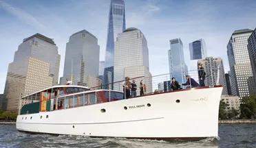 the motor yacht Full Moon cruising past downtown New York City