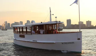 the motor yacht Kingston cruising down the river for a sunset cruise