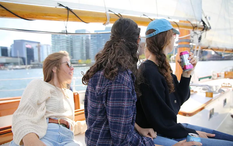 Three friends sailing on a schooner in Boston Harbor