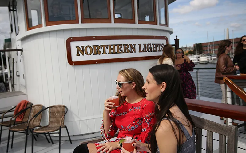 Two friends on the bow of yacht Northern Lights on a sunny day