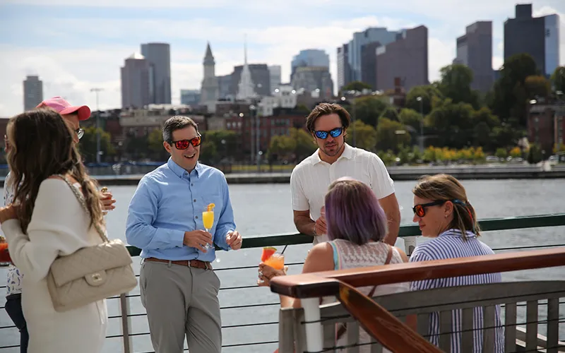 Group of friends enjoying an afternoon sightseeing cruise in Boston Harbor aboard the Yacht Northern Lights