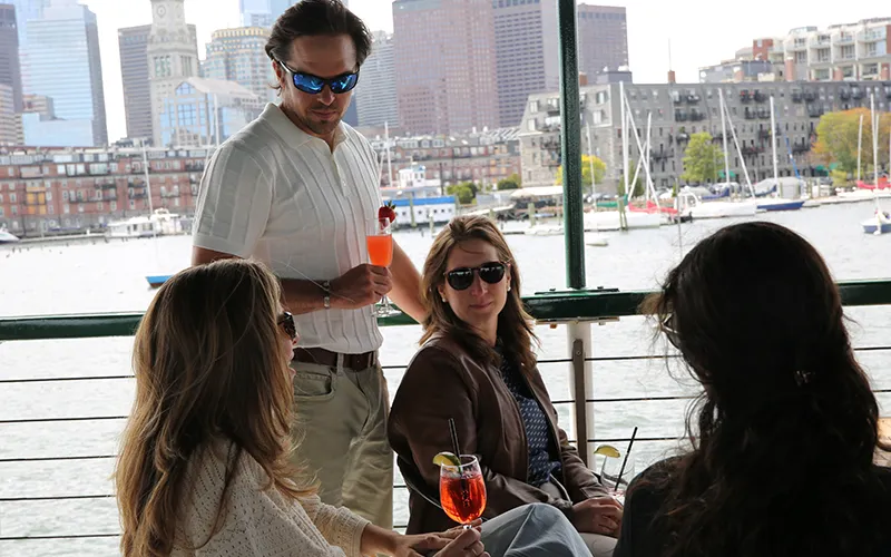 A couple enjoying conversation and drinks on a sightseeing boat tour