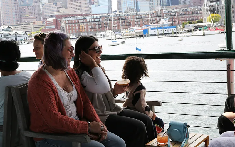 A family sitting on the upper deck of the yacht Northern Lights sightseeing cruise in Boston Harbor