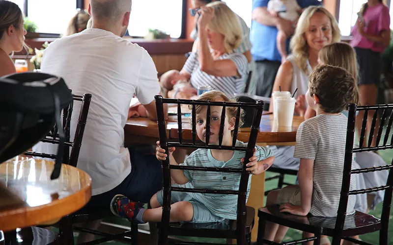 Family at a table in the grand salon of yacht Northern Lights for a Mother's Day Brunch Cruise