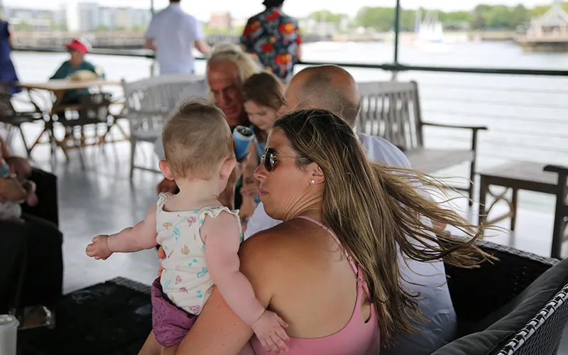 Mother Holding her child on the upper deck of yacht Northern Lights