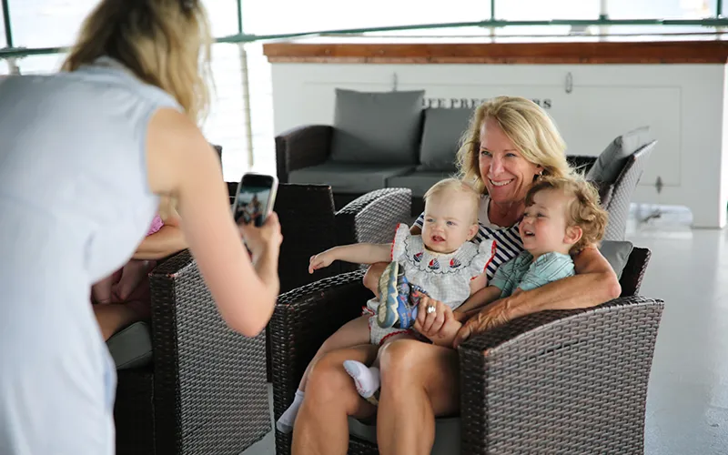 A Grandmother having her photo taken of her and her grandchildren on the yacht Northern Lights