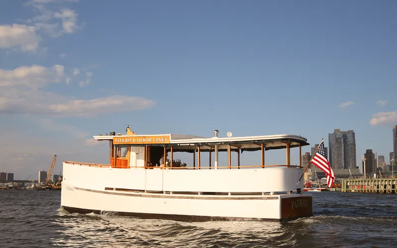 Yacht Patriot Cruising in Boston Harbor at Sunset