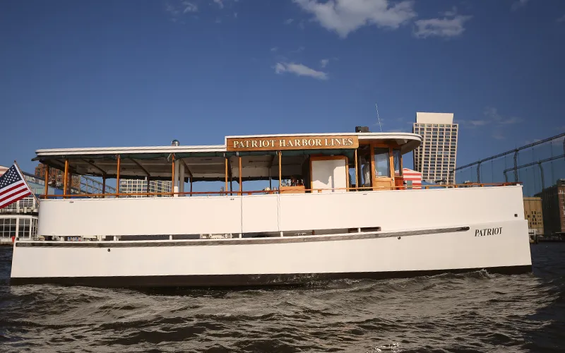 Yacht Patriot Cruising in Boston Harbor at Sunset