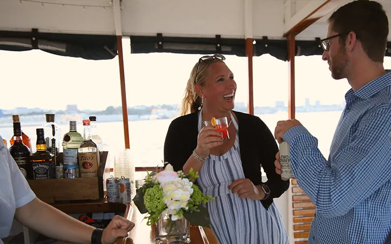 Couple getting a drink at a bar on a boat in Boston Harbor