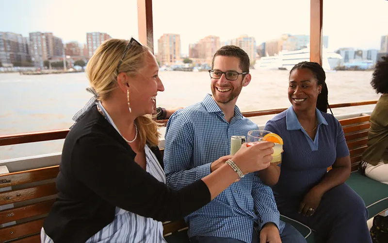 Guests enjoying a sightseeing boat ride in Boston Harbor enjoying drinks