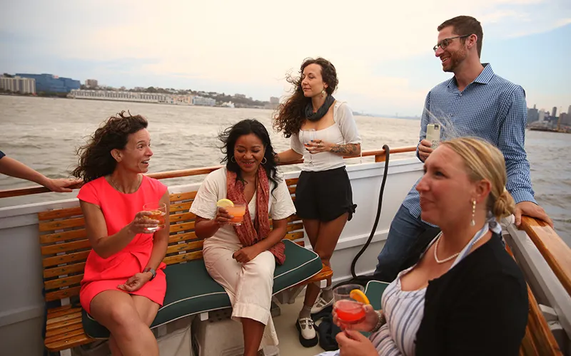 Guests enjoying drinks on a sightseeing boat tour in Boston Harbor