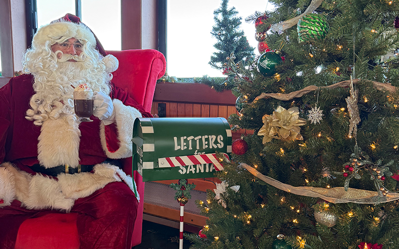 SantaBrunch2 Santa sitting next to a Christmas Tree on a boat