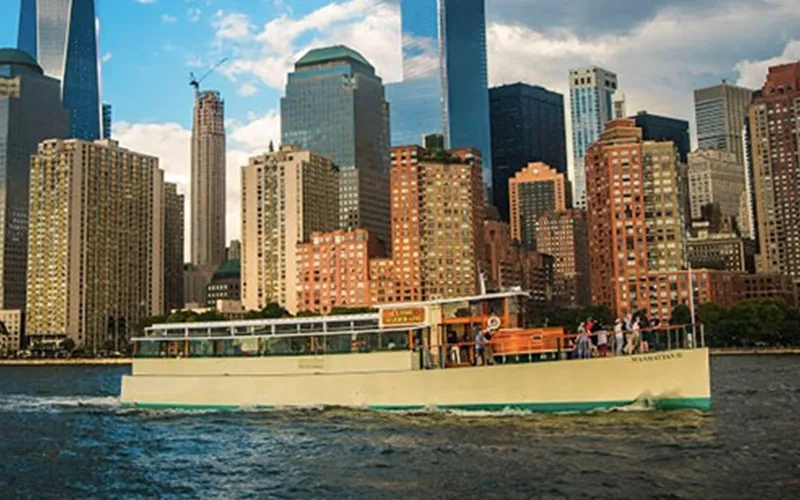 Yacht Manhattan cruising in NY Harbor with the NYC Skyline in the background